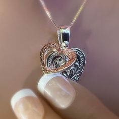 Two hearts that beat as one!! A Rose Gold Scroll Heart sits on top of a Silver Scroll Heart. This romantic design sends a message of love for Valentine’s Day or any special occasion! Two Tone jewelry is on trend. Accented with a cubic zirconia centered in the middle of both hearts, the added sparkle is a nice surprise. Two hearts! Rose Gold Scroll Heart sits on top of a Silver Scroll Heart. Romantic design Sparkling Cubic Zirconia in center of both hearts! Includes 18 inch adjustable chain. Elegant Heart Detail Jewelry For Anniversary, Open Heart Diamond Accents Jewelry For Anniversary, Heart Shaped Diamond Cut Sterling Silver Jewelry, Heart Cut Jewelry With Heart Detail For Anniversary, Fine Jewelry In Rose Gold With Heart Shape, Rose Gold Heart Charm Necklace For Anniversary, Open Heart Jewelry With Diamond Accents For Wedding, Fine Jewelry Double Heart Necklace For Wedding, Elegant Engraved Double Heart Necklace