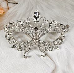 FAST & FREE SHIPPING DURABLE QUALITY: This Crystal Masquerade Mask is made of high-quality alloy and rhinestone diamond. They are manual workmanship, very comfortable to wear. ELEGANT DESIGN: The masquerade mask is encrusted shinny diamond rhinestone and crystal. The intricate and delicate are very glamorous, elegant and luxury. PRINCESS STYLE: You will be the center of attraction at party when you wear the princess style fancy mask. VARIOUS OCCASION: The masks are perfect for Masquerade party, Festivals, Carnival themed party, Formal balls, Halloween party, trick-or-treat, cosplay, Mardi Gras, theatrical plays, fashion shows, pageants, New Year's party, Prom, bridal showers and many other events and occasions. https://happyjewelryworld.etsy.com Butterfly Masquerade Mask, Butterfly Masquerade, Costume Masquerade, Masquerade Wedding, Carnival Themed Party, Happy Jewelry, Royal Crowns, Dazzling Earrings, Royal Tiaras