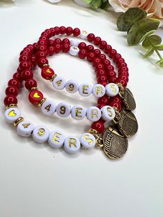 Super cute Stretch 49ers Football Charm Bracelet. Bright Red Glass Beada with White Circle Alphabet Beads  Show your support for your team this season!  All bracelets are 7 inches big  Need a smaller size, message me! 👍🏼  I appreciate your business and do my little happy dance with every sale!  I hope you can see my real passion and attention I give to making each piece.  PLEASE READ BEFORE PURCHASE Look at sizes of bracelets and measure your wrist before ordering.**   Since I use natural gemstones, beads, patina metal, & lava beads, the size, shape, and colors used may vary. Each desktop, Laptop computer, iPad, and cell phone will give you a slightly different look. I try to take my pictures as true as they are in person. Please read the description of each item you are interested in so Personalized Red Name Bracelet With Round Beads, Red Letter Beads For Friendship, Red Team Spirit Bracelets For Sports Events, Red Personalized Bracelets For Team Spirit, Red Personalized Bracelets With Team Spirit Style, Personalized Red Bracelets For Team Spirit, Customized Red Wristband For Friendship, Personalized Red Wristband With Round Beads, Customized Red Beaded Bracelets With Round Beads