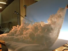 a large amount of white foam is being made on a table in front of a projector screen