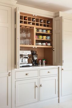 an open cabinet with wine glasses on it