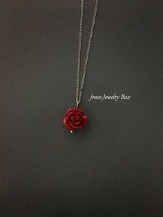 Dark red rose necklace. Red rose is on a delicate but sturdy 18'' stainless steel chain with lobster clasp. If you choose to add initials, please leave the initials in order left to right in the note to sellers box during checkout. *Necklace is available with 1,2 and 3 leaves *15mm Resin rose *Silver plated brass leaves *Stainless steel chain *Handmade with love <3 Like Jmesjewelrybox on Facebook for updates on new jewelry, upcoming sales and giveaways! Plus Facebook fans save 5% :D Find the Red Rose Necklace, Dark Red Jewelry, Choker Necklace Outfit, Silver Necklace Prom, Red Rose Jewelry, Red Flower Necklace, Rose Pendant Necklace, Dark Red Roses, Flower Necklaces