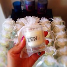 a person holding a small container with the word zen in it