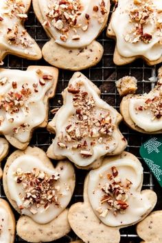 cookies with white frosting and nuts on a cooling rack