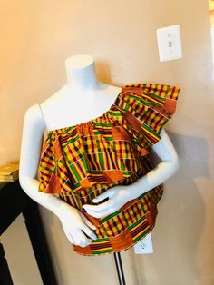 Gorgeous Kente off Shoulder Top for all occasions. Represent your culture in this beautiful Kente blouse. Top can be worn multiple ways. See picture. Top has comfortable elastic band at bust line. Size-Small, Medium & Large Traditional Printed Yellow Tops, Stretch Cotton Off-shoulder Blouse, Multicolor Off-shoulder Bohemian Tops, Bohemian Multicolor Off-shoulder Tops, Bohemian Off-shoulder Multicolor Tops, Bohemian Stretch Cotton Blouse, Traditional Yellow Sleeveless Top, Multicolor Sleeveless Blouse For Beach, Multicolor Printed Sleeveless Blouse