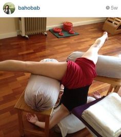 two people doing yoga on their stomachs in a room with wooden floors and hard wood flooring