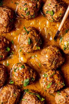 meatballs with sauce and parsley in a skillet