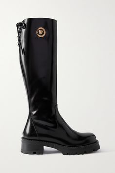 Among the vibrant hues and feminine silhouettes, Versace's latest collections have had a grungy undertone and these knee boots are the perfect expression of that. Made from glossy leather, this pair has lace-up tops and chunky soles. The eye-catching 'Medusa' plaques will make them the star of any outfit. Versace Shoes Women, Versace Boots, Italy 2023, Dr Closet, Leather Knee Boots, Versace Shoes, High Leather Boots, Tall Leather Boots, Fancy Shoes