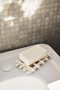 a soap bar sitting on top of a white sink