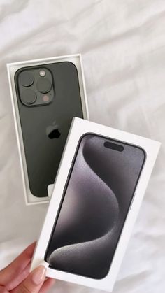 someone holding an iphone in their hand with the box open and it's inside