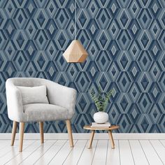 a chair and table in front of a blue wall with geometric designs on the walls