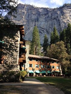 the lodge is surrounded by mountains and trees