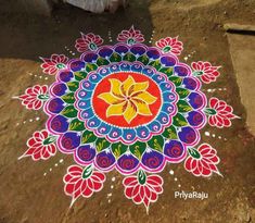 a colorful flower design painted on the ground