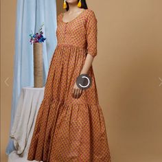 Never Worn. Size Xs. Indian Designer Dress/ Anarkali. Light Weight Fabric And Beautiful Fit. Mustard Yellow And Pink Mulmul Fabric With All Over Hand Block Print, Front Button Detailing And Quarter Sleeves. Bollywood Style Summer Kurta In Maxi Length, Yellow Printed Summer Dress, Yellow Anarkali Dress For Spring, Bollywood Style Summer Maxi Kurta, Summer Bollywood Style Maxi Length Kurta, Festive Orange Maxi Dress, Yellow Festive Straight Kurta Dress, Fitted Orange Kurta For Summer, Fitted Yellow Kurta For Summer