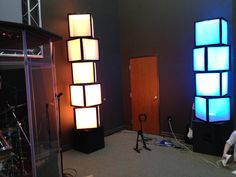 a room with two speakers and lights in it