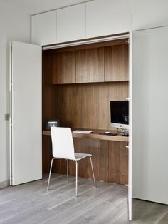 a white chair sitting in front of a wooden desk