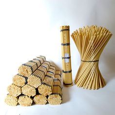 two stacks of bamboo sticks next to each other