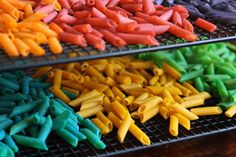 there are many different colored pastas on the rack together and they look to be made out of plastic