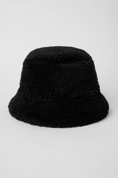 The iconic bucket hat just got a Sherpa update! Top off your cool-weather look with this plush Sherpa bucket hat, featuring a full, textured brim. Plush sherpa (faux fur) Center front woven patch Alo logo Black Hats With Plush Lining For Cold Weather, Black Brimmed Hat With Fleece Lining, Casual Brimmed Hat With Plush Lining, Winter Black Flat Brim Bucket Hat, Black Flat Brim Bucket Hat For Winter, Wide Brim Black Bucket Hat For Winter, Black Brimmed Bucket Hat For Winter, Sherpa Bucket Hat, Winter Bucket Hat