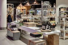 a store filled with lots of bottles of wine and other items on display in front of the counter