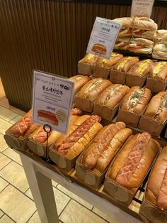 a display case filled with lots of hotdogs and buns on top of each other