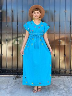 "Vintage turquoise mexican dress, mini floral embroidery, blue maxi dress, boho hippie kaftan, 90s mexico dress, blue latina tunic, coco Gorgeous vintage Mexico dress made in the 90's. Bright and colourful, hand-embroidered flowers. Accents on the neck and sleeves in crochet. Color: Turquoise Fabric: Cotton It comes with a cotton belt, to show your waist, on one side at the bottom of the dress has a small opening (shown in picture #8) Fits size Medium Measurements taken flat: Armpit to armpit 21 Embroidered Blue Maxi Dress For Summer, Spring Festival Maxi Dress With Floral Embroidery, Blue Embroidered Maxi Dress For Summer, Blue Embroidered Maxi Dress For Spring, Blue Maxi Dress With Floral Embroidery For Festival, Turquoise Sundress For Spring, Blue Maxi Length Midi Dress For Festival, Floral Embroidery Maxi Dress For Fiesta, Blue Embroidered Maxi Dress For The Beach