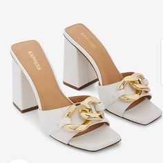 Express Chain Strap Block Heel Mule Sandals Color: White With Gold Hardware Size: 8 Brand New With Tags And Dust Bag With A Chic Chain Strap Detail And Easy Slip-On Design, These Wide Block Heels Are The Perfect Pick To Level Up Any Look. Amazing For Pairing With Jeans, Dresses, Skirts, And More! Open Square Toe Sandals Slip-On Styling Chain Strap Detail; Block Heel 4" Heel Padded Footbed Polyurethane Chic Open Toe Sandals With Gold Chain, Trendy Summer Heels With Gold Chain, White Sandals With Chain Strap For Party, Elegant Summer Heels With Gold Chain, Chic Gold Chain Open Toe Sandals, Elegant White Sandals With Chain Strap, White Chain Strap Heels For Summer, Summer White Heels With Chain Strap, Summer Open Toe Heels With Gold Chain