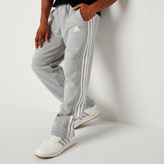 These adidas men's sweatpants were made for your comfort during workouts or lounging at home. Made from soft cotton-fleece with the brand's signature stripes and logo, these pants have an elastic-drawstring waist, side slip pockets, and a straight-leg silhouette. Style them with a t-shirt and hoodie. Front Style: Flat FrontFeatures: DrawstringClosure Type: Full Elastic, DrawstringFit: Regular FitPockets: 2 Side Slip PocketsRise: At WaistFiber Content: 78% Cotton, 22% PolyesterFabric Description… Affordable Men's Cotton Sweatpants, Cheap Men's Jogging Sweatpants, Men’s Fashion Sweatpants, Men’s Nike Sweatpants, Cheap Moisture-wicking Sweatpants For Men, Mens Sweatpants, Cotton Fleece, Adidas Men, Straight Leg