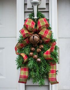 a christmas wreath hanging on the front door