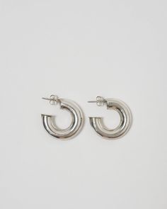 Silver Large Hoop Earrings Contemporary Silver Round Hoop Earrings, Silver Round Hoop Earrings Contemporary Style, Contemporary Silver Hoop Earring, Contemporary Single Silver Hoop Earring, Modern Sterling Silver Small Hoop Jewelry, Silver Polished Sterling Silver Hoop Earrings, Silver Sterling Hoop Earrings With Polished Finish, Silver Small Hoop Single Earring, Modern Rounded Sterling Silver Jewelry