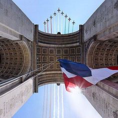 the view from below looking up at an american flag