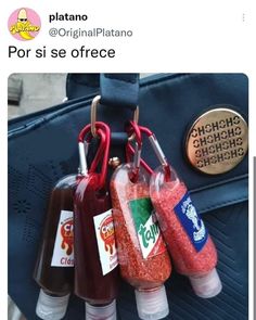 three bottles filled with condiments sitting on top of a blue bag next to a coin