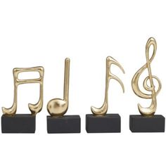 three gold musical notes are placed on black blocks and each has a treble in the middle