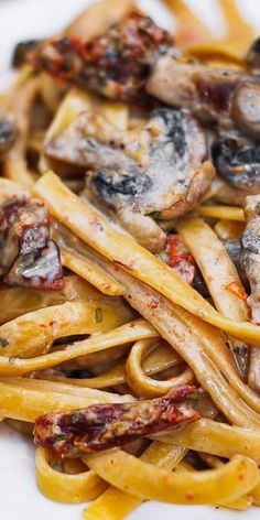 pasta with mushrooms and sauce on a white plate