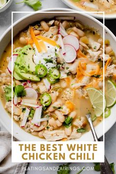 the best white chicken chili recipe in a bowl with limes and cilantro