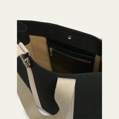 Jacquemus wool canvas tote bag with contrasting grosgrain in a structured construction  Flat top handles Open top with a snap closure  Engraved square carabiner Back patch pocket Interior double-zipped pocket  Approx. 15.4"H x 5.1"W  Made in Italy Modern Black Canvas Bag With Top Handle, Black Top Handle Modern Canvas Bag, Modern Black Top Handle Canvas Bag, Luxury Black Canvas Bag With Leather Handles, Luxury Black Canvas Bag, Classic Black Canvas Bag, Black Rectangular Satchel With Canvas Lining, Luxury Black Canvas Bag For Everyday, Functional Rectangular Satchel With Canvas Lining