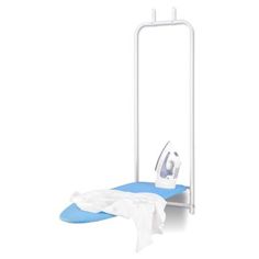 an ironing board with clothes on it next to a dryer and towel rack