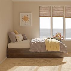 a bed sitting in a bedroom next to two windows with blinds on each window sill