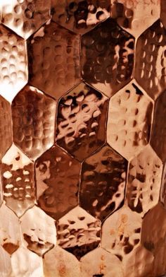 a close up view of a vase made out of metal hexagonals and rust