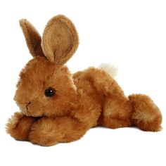 a brown stuffed rabbit laying on its side