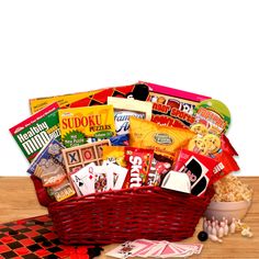 a red basket filled with lots of different types of food and snacks on top of a checkered table cloth