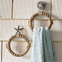 two towels hanging on the wall next to a towel rack and starfish hooks