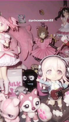 some anime figurines are on display in a room with pink walls and flooring