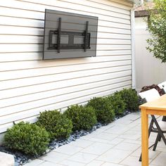 a television mounted to the side of a house