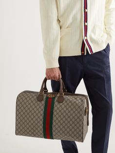 Made in Italy, this durable 'Ophidia' coated-canvas duffle bag features the iconic 'GG Supreme' monogram and tricolour webbing trims. Ideally sized for weekend getaways or as a carry-on, it also has a detachable shoulder strap to leave your hands free. Duffle Bag For Men, Gucci Collection, Canvas Duffle Bag, Gucci Jewelry, Alessandro Michele, Louis Vuitton Speedy Bag, Mr Porter, Weekender Bag, Weekend Getaways