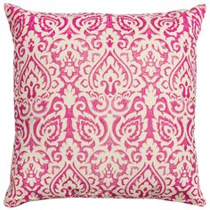 a pink and white pillow with an ornate design on the front, sitting against a white background