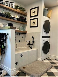 a dog's paw prints are on the wall in this laundry room