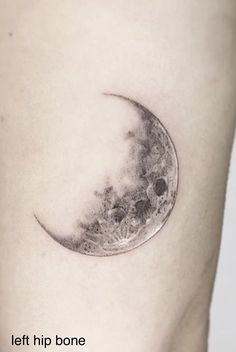 a small crescent moon tattoo on the right thigh