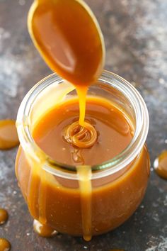 caramel sauce being poured into a glass jar