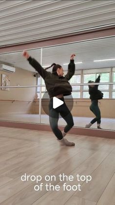 a group of people dancing on top of a wooden floor in front of a mirror